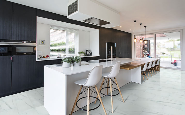 luxury vinyl tile flooring in kitchen with dark cabinets and white kitchen island
