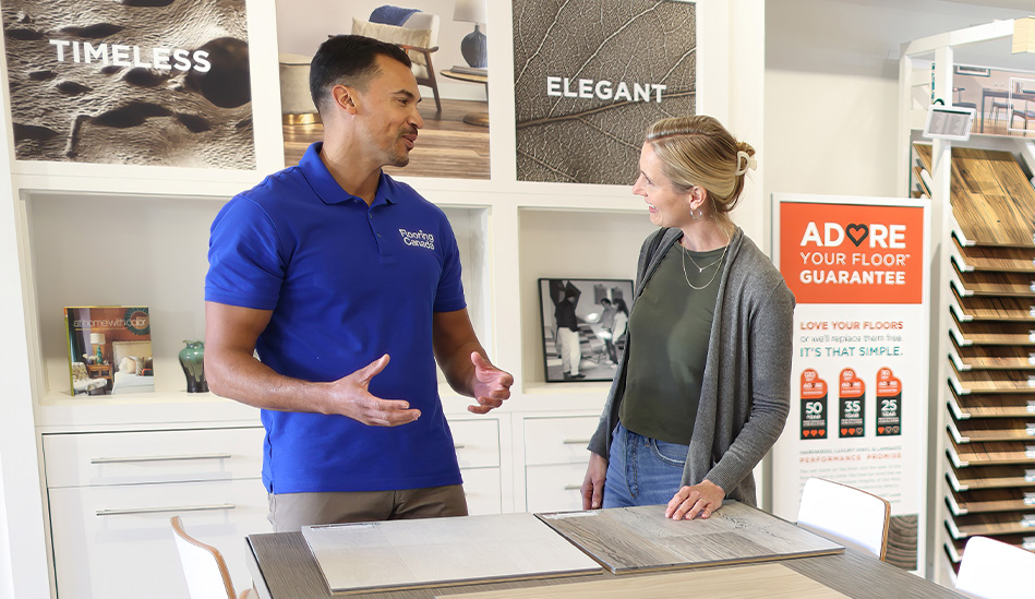 woman looking at flooring samples in showroom with flooring expert